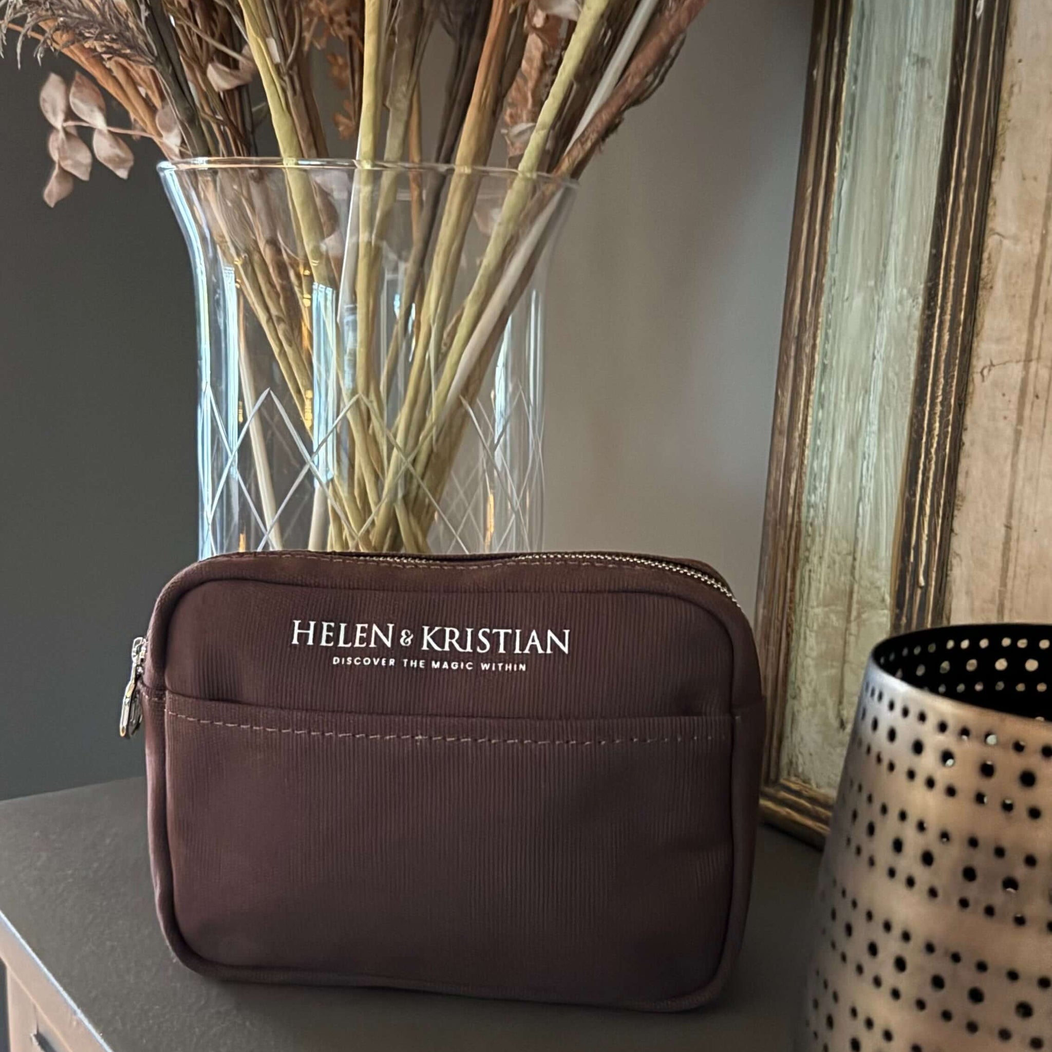 Stylish Nipsy Roasted Chestnut Clutch on table with decor.