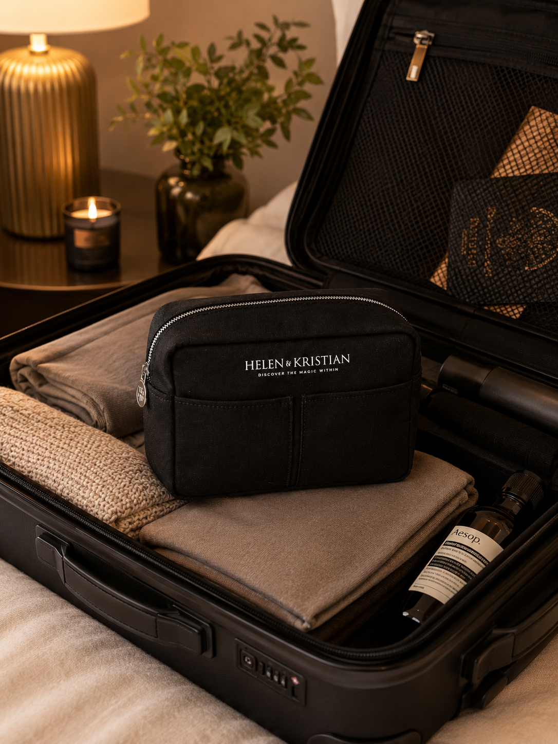Nesty - Stor Toalettmappe - Black Raven packed in a stylish suitcase with cozy essentials nearby.