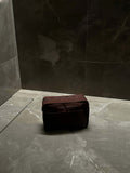 Nesty Roasted Chestnut Large Toiletry Bag by Helen & Kristian on a sleek marble surface.