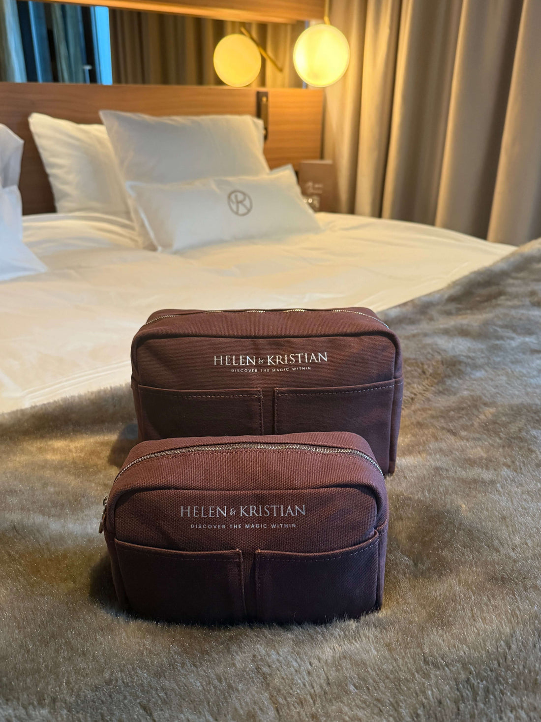 Nesty Roasted Chestnut Large Toiletry Bag by Helen & Kristian on a bed, perfect for organized travel, featuring elegant design.