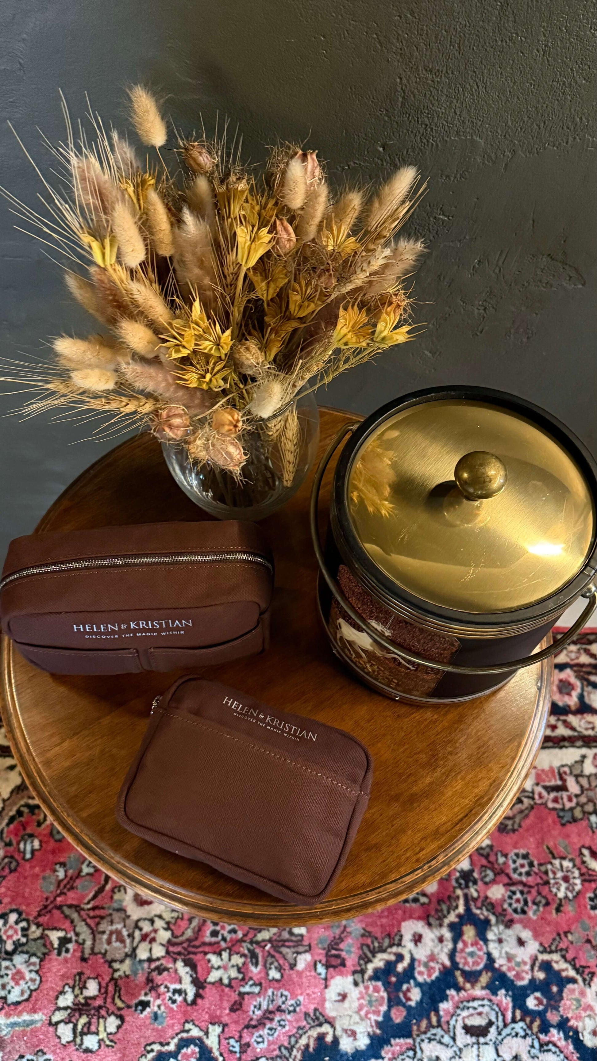 Elegant Nipsy Roasted Chestnut Clutch with dried floral decor on wooden table