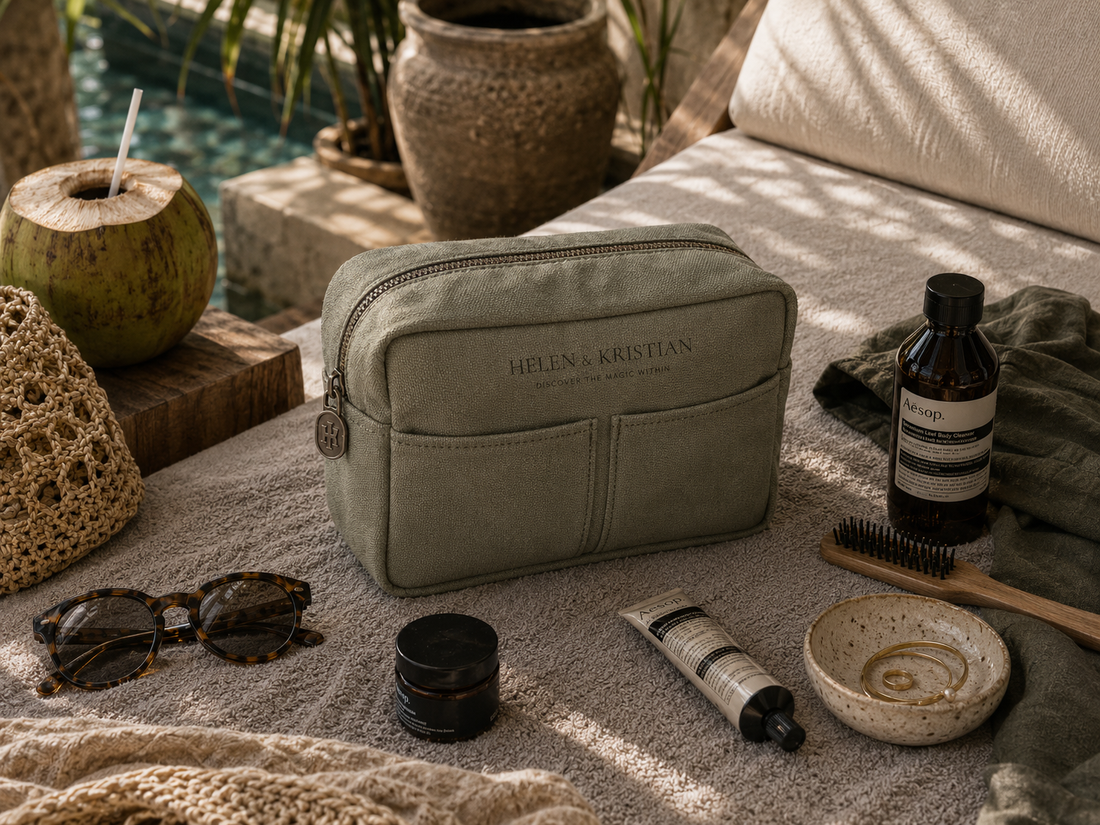 Nesty - Stor Toalettmappe - Deep Forest laying on a textured surface surrounded by beauty products and sunglasses.