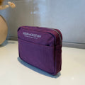 Purple cosmetic pouch with 'HELEN & KRISTIAN' branding .