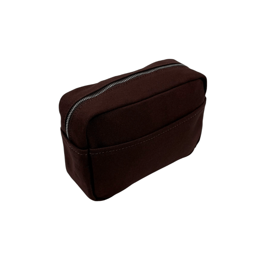 Brown toiletry bag from Helen & Kristian with a zipper on a white background