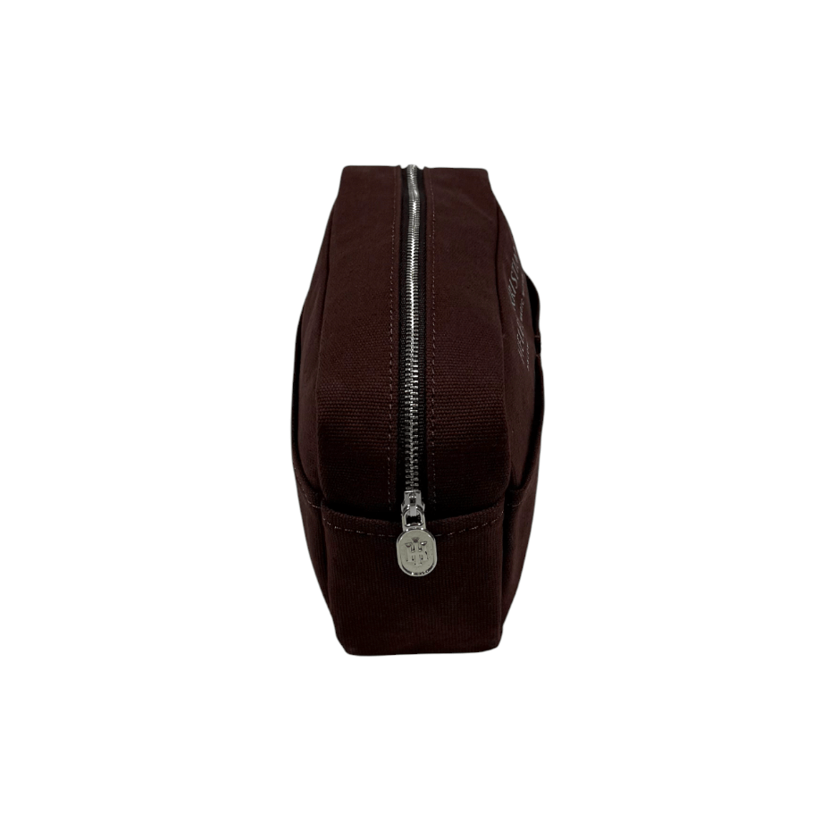 Brown pouch from Helen & Kristian with a silver zipper on a white background
