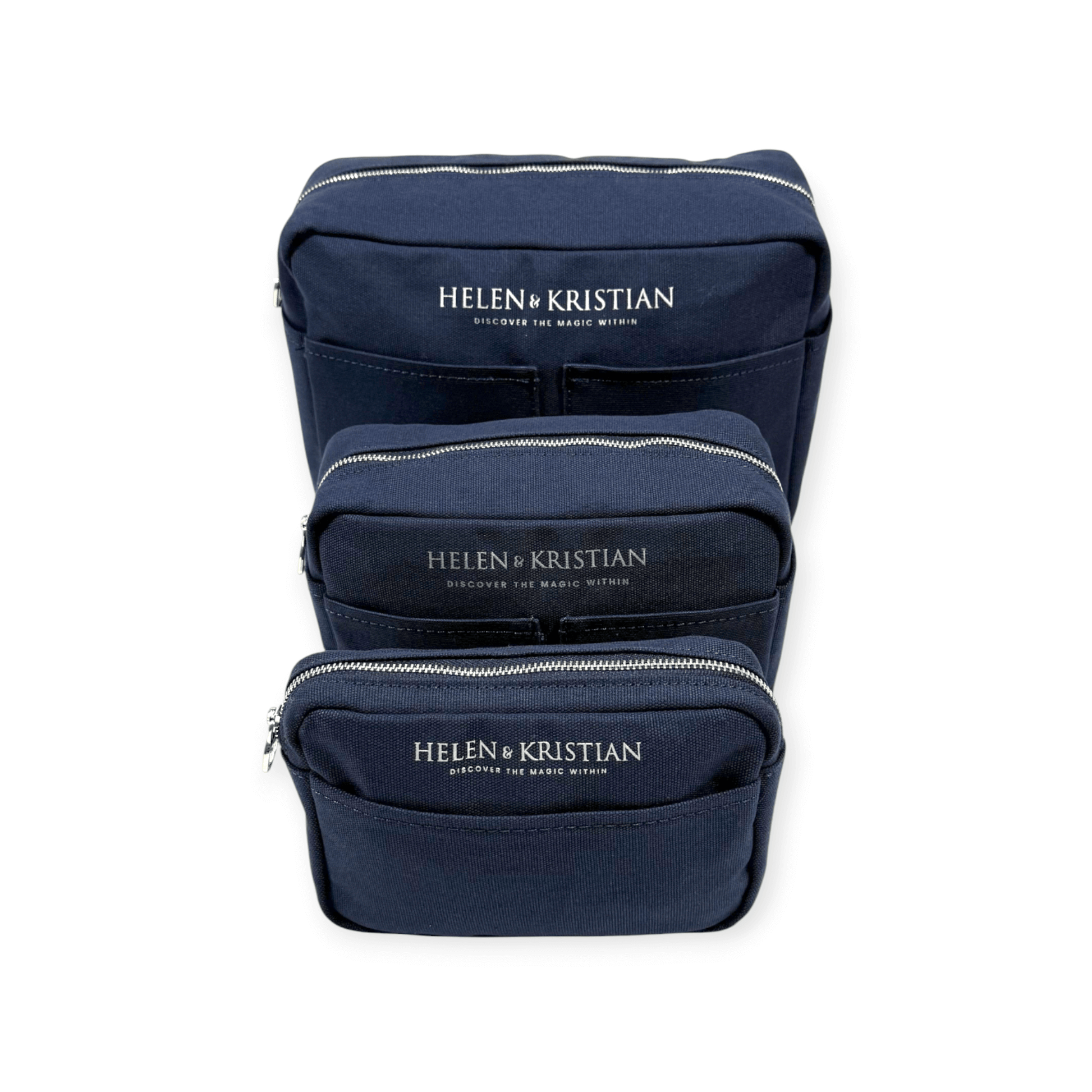 Set of three navy toiletry bags with zippers, featuring the Helen & Kristian logo on each bag.