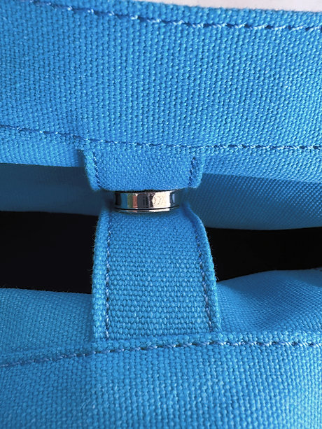 Close-up of ice blue Nordic Wave organizer with metal buckle and strap detail, showcasing durable stitching and fabric quality.