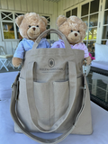 Beige Organizer Viking Haze with two teddy bears in front of a glass window backdrop.